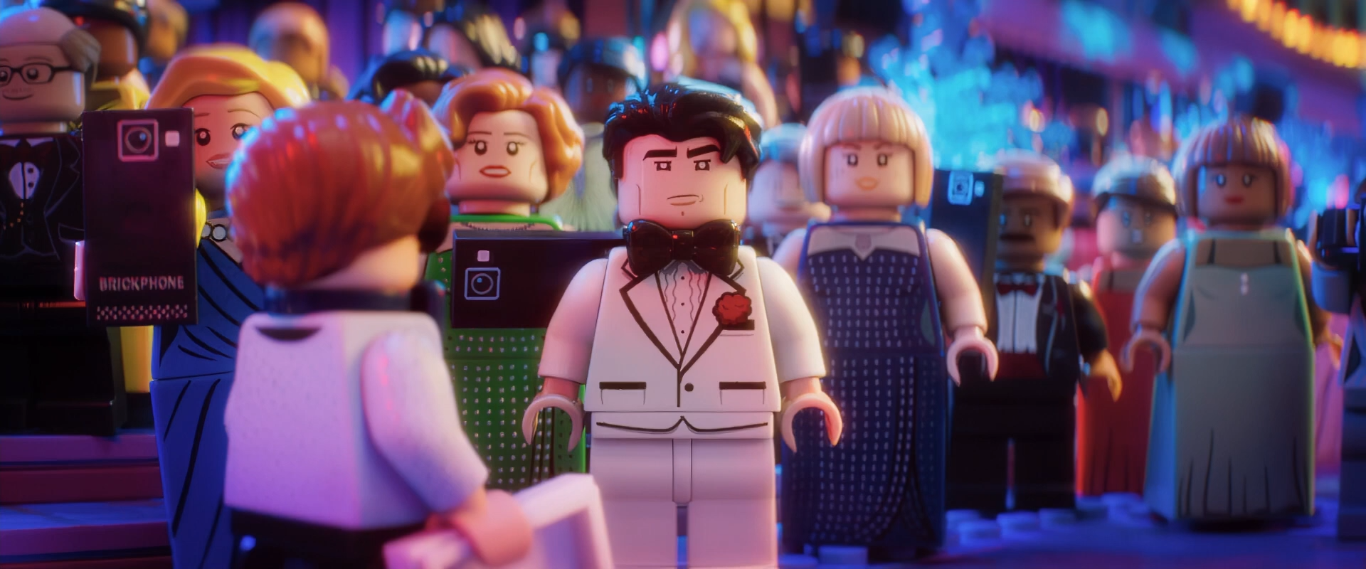 Bruce Wayne, in a white tuxedo, staring across the gala room in the LEGO Batman Movie scene